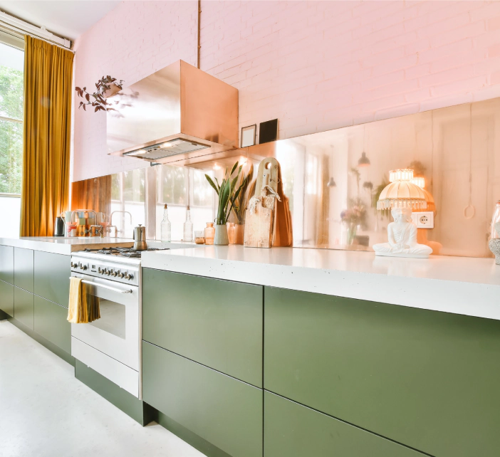 kitchen with light pink cabinets and a sage green countertop with a white cover